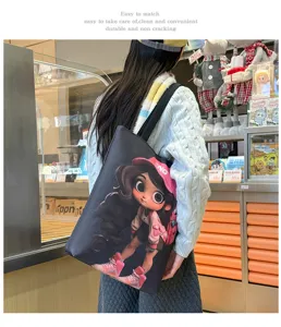 Detailed view of a stylish black canvas tote bag featuring a cute cartoon girl print design.