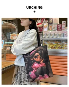 Stylish canvas shoulder bag with cute cartoon girl print, large capacity student bag.