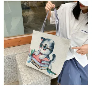 Casual woven canvas shoulder bag featuring cute cartoon cat reading book pattern, large tote.
