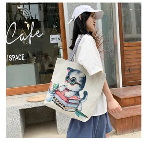 Casual canvas tote bag with cute cat and book print, large capacity shoulder bag for daily use.