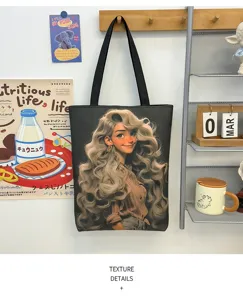 Canvas tote bag detail view, showcasing high-capacity design, sturdy black straps and cute graphic print.