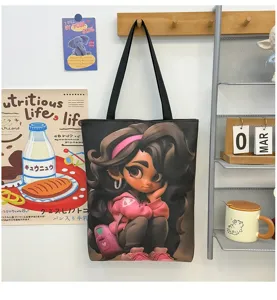 Canvas tote bag detail showing the cute 3D cartoon girl graphic print and black shoulder strap.