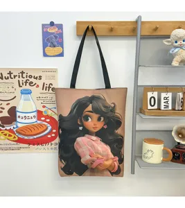 Detail shot of the cute cartoon girl printed canvas tote bag hanging on the wall rack display.