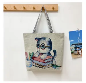 Close-up detail of cute cat canvas tote bag, woven tapestry design, casual everyday shoulder bag.