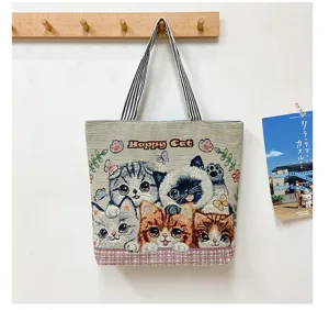 Canvas tote bag with cute woven cat pattern, spacious casual shoulder bag for daily use.