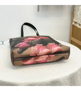 Detailed view of the stylish canvas shoulder tote bag with unique graphic print design.