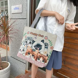 Cute canvas tote bag with lovely cat pattern, stylish shoulder bag for women daily shopping.
