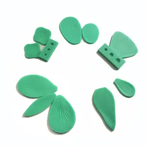 Detailed view of green silicone flower petal and leaf mold set for baking crafts.