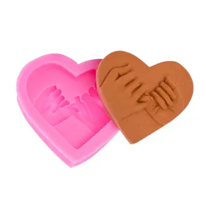 Detailed view of the heart gesture silicone mold and finished handmade craft piece.