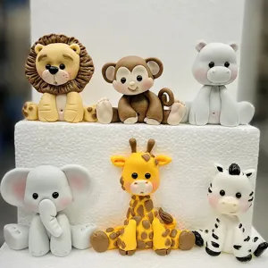 Detail shot of cute cartoon animal silicone molds and fondant figurines for cake decoration.
