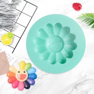 Silicone cake mold with cute smiley flower design, perfect for DIY baking and fondants.