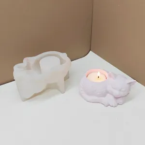 Sleeping cat silicone mold and finished candle holder set for DIY home decor crafts.
