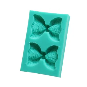 Green silicone bow mold for DIY fondant, chocolate, cake decoration, and ultra-light clay crafts.