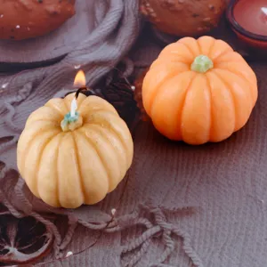 Pumpkin scented candle detail shot, featuring two cute fall festival decor candles.