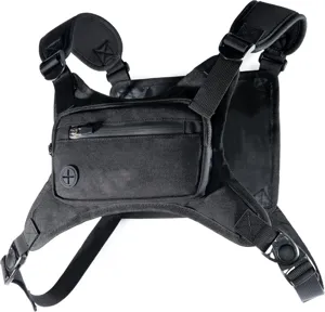 Detailed view of black tactical chest bag, durable nylon running rig with secure zippers and buckles.