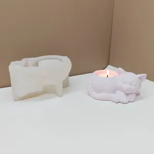 Detailed view of a sleeping cat silicone mold and finished candle holder DIY craft display.