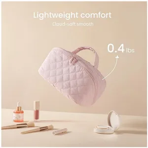 Pink quilted cosmetic bag with cloud-soft texture, lightweight portable travel makeup pouch.