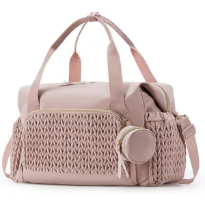 Rosa große Reise-Wickeltasche mit gewebter Vordertasche und abnehmbarem runden Täschchen.
