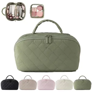 Large capacity quilted cosmetic bag with handle, multiple storage compartments for travel.