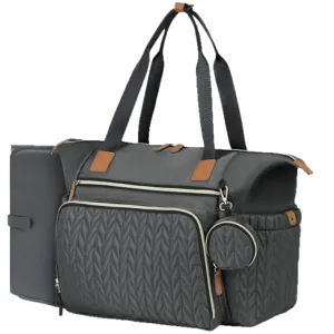 Detail view of the large quilted diaper bag featuring a matching changing pad and round pouch.