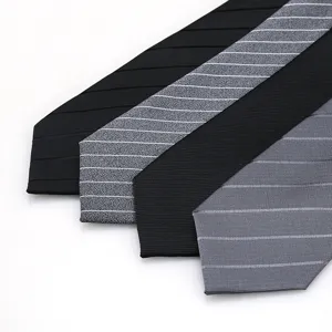 Detailed view of men's business ties in black and grey with various striped textured designs.