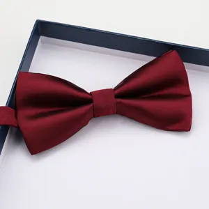 Burgundy silk bow tie close up view, elegant formal neckwear for weddings, groom and business suits.