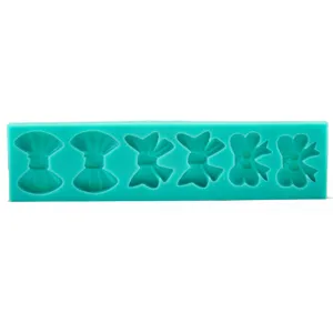 Mint green silicone bowknot mold for fondant cake decoration and ultra-light clay crafts.