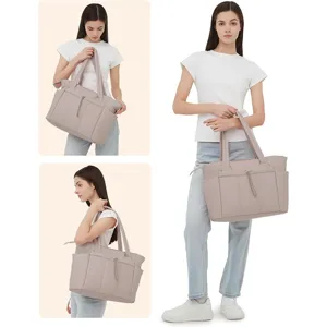 Quilted tote bag detail showing soft padded fabric, dual shoulder straps and front pocket.