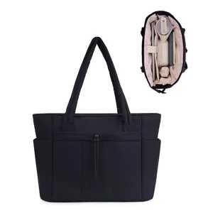 Black quilted tote bag for women, lightweight casual shoulder bag with multiple exterior pockets.
