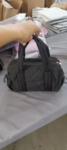 Black nylon puffer handbag with top handles, zipper closure, and casual daily style.