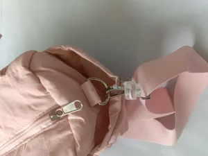 Pink puffer shoulder bag detail, lightweight nylon fabric, durable hardware, casual daily use.