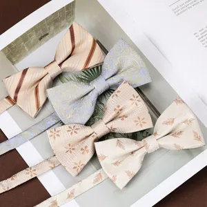 Close-up detail of four stylish men's bow ties with assorted patterns for wedding suits.