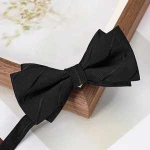 Classic black bow tie detail, premium textured fabric, elegant formal wear accessory for men.