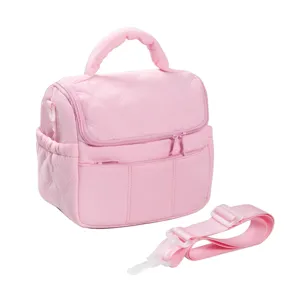 Pink quilted lunch bag detail showing insulated cooler design, top handle and detachable strap.