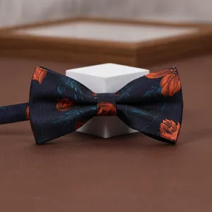 Men's vintage floral jacquard bow tie, elegant navy blue and orange design for suits.