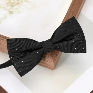 Classic black bow tie with white polka dots, elegant fabric detail for formal wear suit.