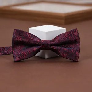 Wine red jacquard bow tie detail shot, elegant fabric texture for wedding and formal wear.