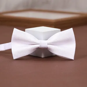 White textured bow tie detail shot, elegant fabric for men's formal suit wedding wear.