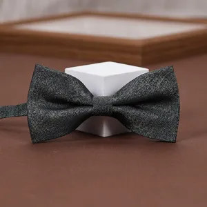 Classic herringbone bow tie detail shot, elegant fabric texture for men's formal suits and weddings.