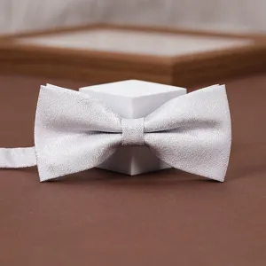 Detail view of men's silver grey textured bow tie, perfect for wedding suits and formal wear.