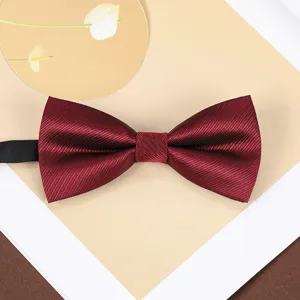 Wine red striped bow tie detail close-up, classic style for formal wear and weddings.