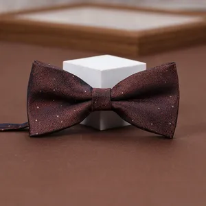 Burgundy bow tie with gold shimmer for men women wedding suit formal party accessory detail view.