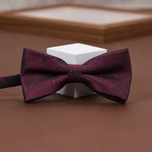 Burgundy glitter bow tie detail, elegant accessory for formal wear and wedding suits.