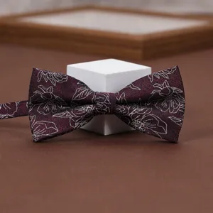 Burgundy floral bow tie for men, elegant wedding suit accessory with silver line art pattern.