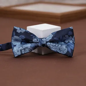 Close-up detail of the elegant blue floral jacquard bow tie, fine fabric and exquisite pattern.