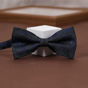 Close-up detail of a dark blue retro jacquard patterned men bow tie with floral and stripe.