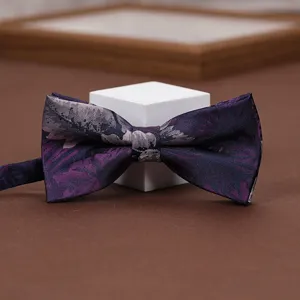 Exquisite purple floral bow tie detail, elegant fabric accessory for weddings, proms and formal events.