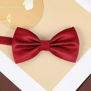 Classic wine red bow tie detail showcasing fine textured fabric for formal wedding suits.
