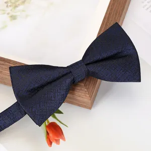 Close-up of a sophisticated dark blue textured bow tie, ideal for formal business and wedding suits.