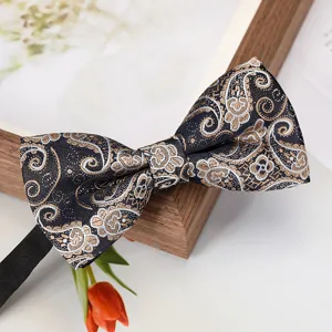 Men's business formal bow tie with elegant gold silver paisley jacquard pattern detail view.